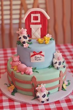 a three tiered cake decorated with farm animals