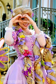 a woman in a dress with braids and flowers on her head