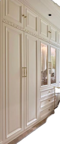 an image of a kitchen setting with white cabinets and marble counter tops in the middle