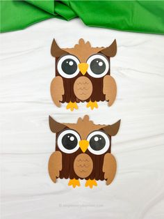 two cut outs of an owl with big eyes