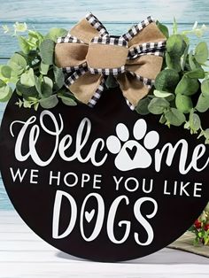 a welcome sign with a dog's paw on it and the words, we hope you like dogs