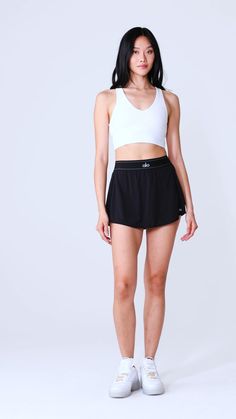 Take your look from the court to post-practice plans in the Match Point Tennis Skirt. It has a boxer-style elastic waistband (so on-trend), built-in shorts with a side pocket, and a mini-length hem. It’s made from a lightweight, slightly swishy performance fabric and has a cute, swingy fit. Wear it with a hoodie, a bra top, or even a blazer—this skirt aces the game every time. Workout Skirt, Tennis Skirt Black, Skirt With Shorts Underneath, Skirt With Shorts, Match Point, New Sneakers, A Workout, Shopper Tote, Fitted Skirt