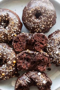 chocolate donuts with sprinkles on a plate