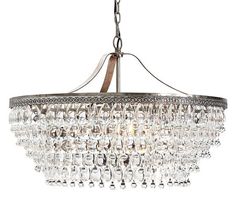 a chandelier hanging from the ceiling with clear crystal drops on it's sides