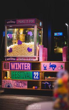 an old fashioned popcorn machine sitting in front of a building