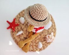 a crocheted hat and starfish on top of a woven mat