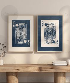 two framed playing cards sitting on top of a wooden table