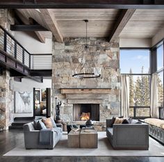 a living room filled with furniture and a fire place in the middle of a room