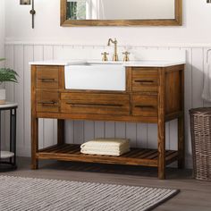 a bathroom vanity with a mirror above it and a rug on the floor next to it