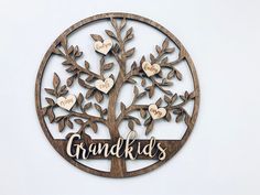 a wooden sign with the words grandki's on it and a family tree