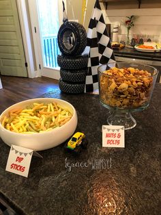 a table topped with a bowl of cereal next to a toy car