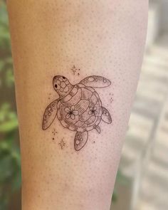 a small turtle tattoo on the leg