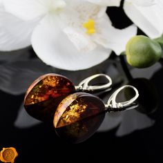 "\"Shoot for the Amber Moon. Even if you miss it, you will land among the stars.\" This pair of dazzling Amber Moon earrings beholds perfectly crafted cognac Baltic Amber set in 925 Hallmarked Silver. Lever-back closure ensures a secure and comfortable fit. Smooth, shiny and glossy. Handcrafted to a standard of perfection will make a meaningful nature-inspired gift or just another wonderful love token for yourself or your special someone. Presented in a luxury gift box. *Cognac Baltic Amber 40 - Handmade Amber Teardrop Earrings, Handmade Amber Earrings Gift, Handmade Amber Earrings For Gift, Unique Amber Earrings With Ear Wire, Amber Drop Earrings With Ear Wire, Brown Oval Earrings As A Gift, Brown Oval Earrings Gift, Brown Oval Earrings For Gift, Hypoallergenic Teardrop Clip-on Earrings As Gift