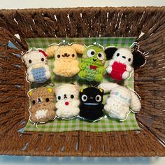 small crocheted stuffed animals are displayed in a wicker basket on a table