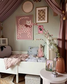 a child's bedroom decorated in pink and white