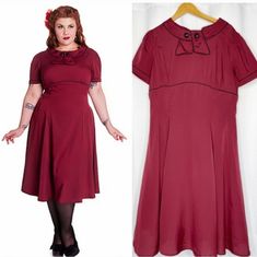 Step Back Into The Glamorous World Of The 1950s With This Stunning Hell Bunny Vixen Retro Style Party Dress In Burgundy! Perfect For Any Occasion, From Parties To Cosplay Events, This Dress Is Designed To Fit And Flatter Any Figure With Its Fit And Flare Style. The Dress Is Made From High-Quality Materials And Is In Very Great Condition, Never Used. The Dress Features A Sailor-Style Collar, Adding A Touch Of Vintage Charm To The Overall Look. The Beautiful Burgundy Colour Is Perfect For Any Seas Retro Vintage Short Sleeve Party Dress, Retro Short Sleeve Vintage Dress For Party, Retro Short Sleeve Vintage Party Dress, Rockabilly Vintage Dress For Retro-themed Events, Red 1950s Style A-line Vintage Dress, Vintage Short Sleeve Dress For Costume Party, 1950s Style Vintage Dress For Events, 1950s Style Red A-line Vintage Dress, Vintage Burgundy Dress For Evening