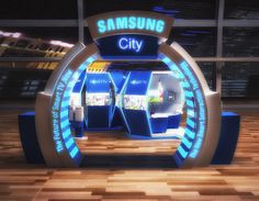 the samsung city booth is lit up with blue and white lights on it's sides