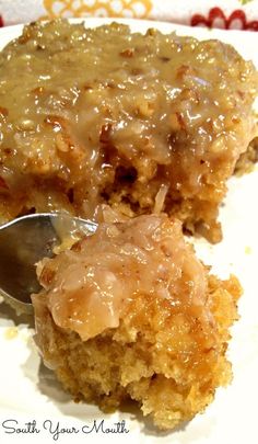 a close up of a piece of cake on a plate with a spoon in it