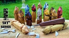 several wooden birds are sitting on top of a piece of wood with a knife in it