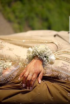 a woman laying on top of a bed holding a bouquet of flowers