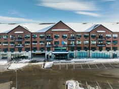 an aerial view of a building with snow on the ground