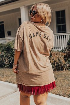 Show your team spirit in this classic style graphic tee! Features super soft brown colored fabric with a vintage inspired look, a round neckline, small front touchdown graphic, back 'Game Day' graphic, short sleeves, and a relaxed classic tee silhouette that falls into a straight hemline. Measurements 2XL : Bust 48", Hip 48", Length 29.5", Sleeve Length 8", Waist 46". 3XL : Bust 52", Hip 52", Length 29.5", Sleeve Length 8", Waist 50". Sporty Brown Short Sleeve T-shirt, Casual Letter Print T-shirt For Tailgating, Brown Graphic Tee With Letter Print, Team Spirit Short Sleeve T-shirt For Tailgating, Brown Distressed Short Sleeve Top, Brown Short Sleeve Distressed Top, Casual Tops With Team Name For Tailgating, Casual Crew Neck Tops For Tailgating, Vintage Brown Tops With Text Print