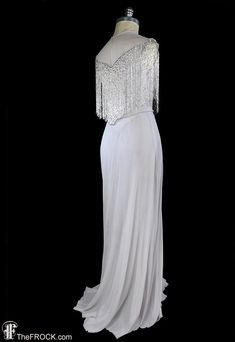 1930s gown art deco beaded fringe silk chiffon formal Elegant Wedding Flapper Dress With Rhinestone Fringe, Elegant Beaded Fringe Flapper Dress For Wedding, Glamorous Wedding Flapper Dress With Rhinestone Fringe, Elegant Wedding Flapper Dress With Beaded Fringe, Sleeveless Evening Dress With Rhinestone Fringe For Wedding, Silver Elegant Flapper Dress For Evening, Elegant Silver Flapper Dress For Evening, Elegant Beaded Fringe Flapper Dress For Prom, Elegant Floor-length Flapper Dress For Gala