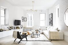 a living room filled with furniture and white walls