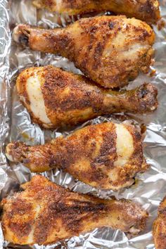 baked chicken wings on tin foil with seasoning in the middle, ready to be cooked