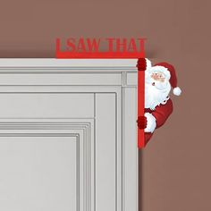 a santa clause is peeking out from behind a door with the word saw that on it