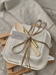 three wooden spoons tied up on top of napkins with a label that says, i love you