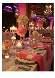 a long table with candles and flowers on it is set up for a formal function