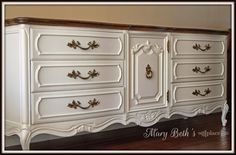 an antique white dresser with gold handles and knobs on the doors is shown in this image