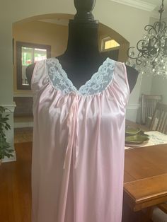 A summer beauty! A lightweight sleeveless nightgown with lace trim on the v-shaped neckline. Decorative tie at the bustling. In good vintage condition with no rips or stains. The bust measures 18 inches from armpit to armpit laying flat, 36.5 inches from shoulder to hem. Pinehurst. Made in the USA Nylon machine washable Sleeveless Lace Nightgown For Pajama Party, Lace Nightgown With Lace Trim For Pajama Party, Lace Sleeveless Sleepwear For Pajama Party, Sleeveless Lace Nightgown For Home, Sleeveless Lace Sleepwear, Pink Sleeveless Lace Sleepwear, Sleeveless Pink Nightgown For Sleep, Pink Lace Camisole Nightgown, Pink Sleeveless Nightgown For Sleep