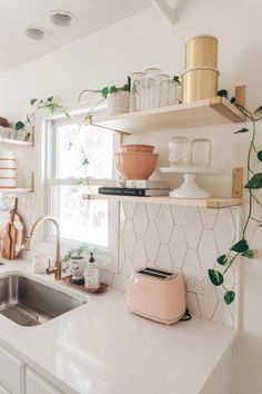 a kitchen with white counter tops and shelves