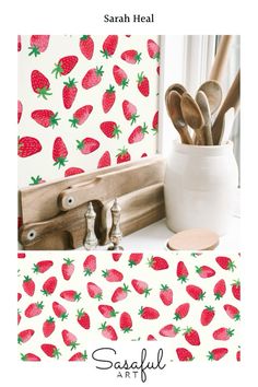 there is a strawberry wallpaper with spoons and utensils in the vase