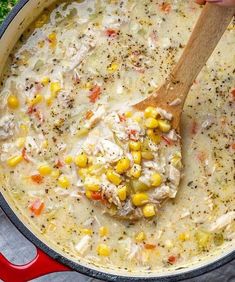 a pot filled with chicken and corn soup