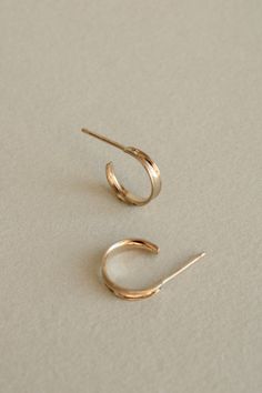 A lightweight everyday hoop. An idea born from the contour of inverted channel wire, the Plié reflects light to multiply its weight in visual interest. These simple hoops are lovely on their own, yet look excellent stacked for those with multiple lobe piercings. Available in solid 14k white or yellow gold. Everyday 14k Gold Earrings With A Modern Twist, Minimalist 14k White Gold Filled Hoop Earrings, Minimalist Small Hoop Yellow Gold Wrap Earrings, Minimalist Small Hoop Yellow Gold Earrings, Minimalist Yellow Gold Hoop Wrap Earrings, Modern Twist Yellow Gold Hoop Earrings For Everyday, Minimalist Small Hoop Earrings In Recycled Gold, Dainty Yellow Gold Wrap Earrings For Everyday, Minimalist Small Hoop Tarnish Resistant Wrap Earrings