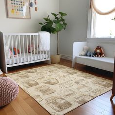 a baby's room with a crib, chair and rug in the corner