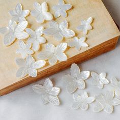 These mother of pearl flowers are delicate and beautiful at quite unique shapes, perfect to be used in earring, headwear or ring design. Size: approx 2-4mm thick, 20-45mm size, I divide them into 3 sizes. size S: 20-30mm, mainly 25mm approx. size M: 32-38mm, mainly 35mm approx. size L: 40-45mm, mainly 42mm approx. Quantity: 5pcs Material: natural white mother of pearl You can leave a message to me saying you want the larger or smaller ones. ❤ Pictures are taken under afternoon natural sunlight❤ White Handmade Shell For Wedding, White Shell For Wedding, White Mother Of Pearl Shell For Wedding, Carved Flowers, Shell Flowers, Pearl Flowers, Unique Shapes, Carved Shell, Pearl Design