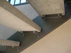 the bottom part of a concrete structure with metal railings