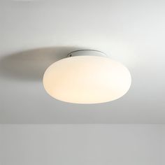 a white ceiling light hanging from the ceiling in a room with no one around it