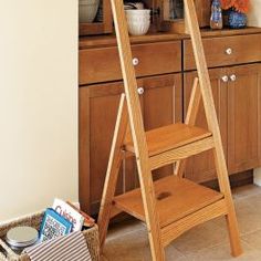 a wooden ladder stands in the corner of a kitchen