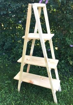 a wooden step ladder sitting in the grass