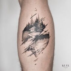 a man's leg with a mountain and forest tattoo on the side of his calf