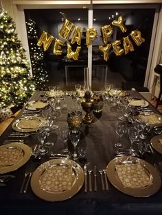 a table set with plates and silverware for a new year's eve celebration