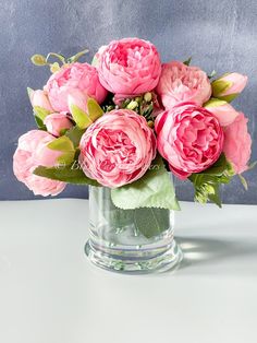 pink flowers in a glass vase on a table