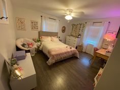 a bedroom with hardwood floors and white walls