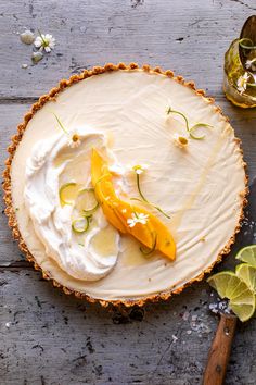 a pie topped with whipped cream and sliced oranges