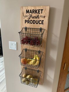 a wooden sign that says market fresh produce hanging on the wall next to some fruit